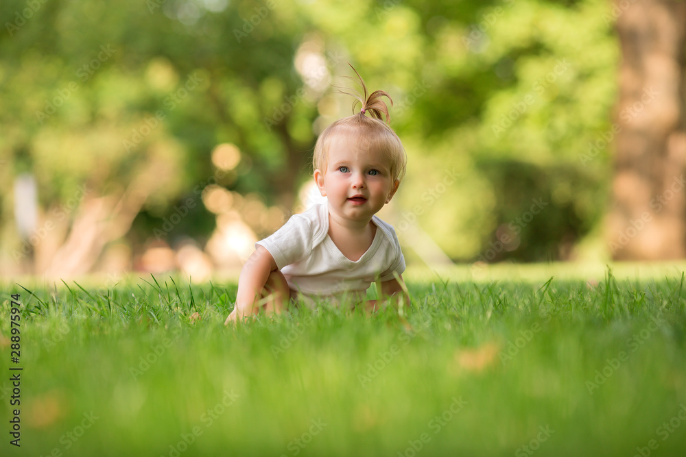 baby girl in a white sandpit on the green grass playing pyramid baby girl in a white sandpit on the green grass playing pyramid