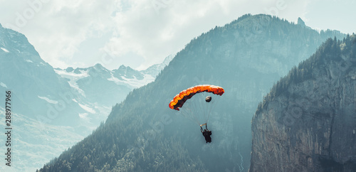Basejumper landing in the Lauterbrunnen Valley