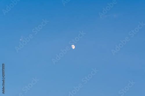 Blue sky and half moon