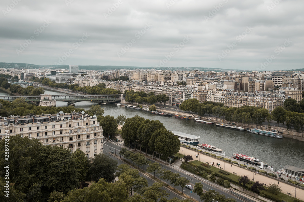 Landscape aerial moody view of Seine river and cityscape in Paris, France on a cloudy day