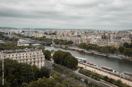 Landscape aerial moody view of Seine river and cityscape in Paris, France on a cloudy day © Sergio Gonzalez
