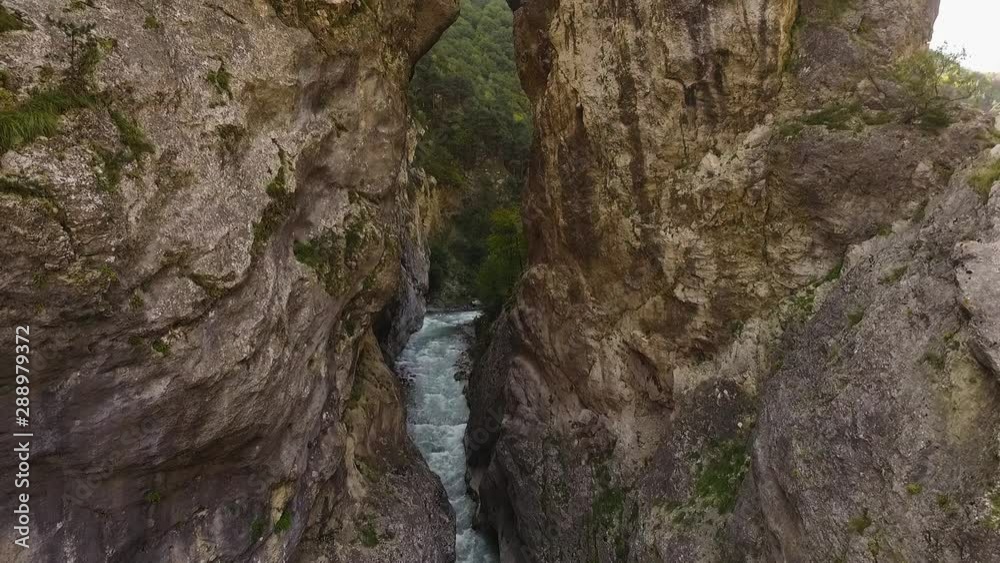 Rough river runs through the rock. North Ossetia Rough river runs through the rock. North Ossetia