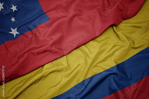 waving colorful flag of colombia and national flag of Samoa .