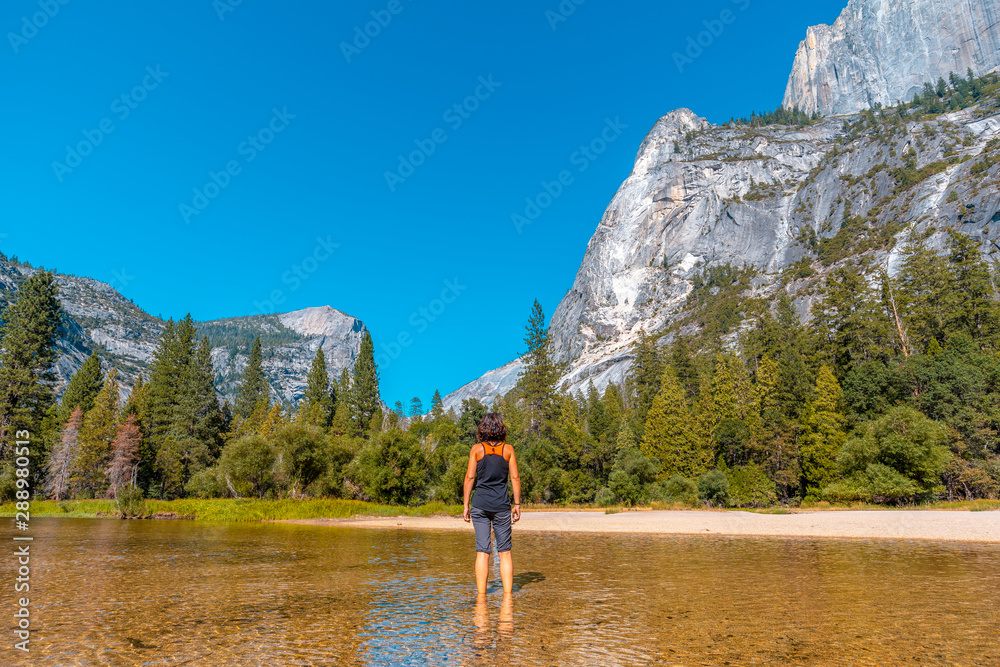 Mirror lake, a young woman with a black shirt in the lake water. California, United States