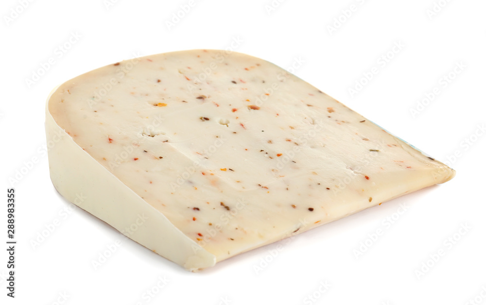 Piece of tasty cheese with basil and paprika isolated on white