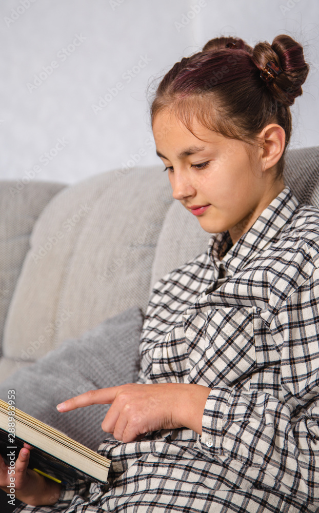 Little girl  reading a book ...