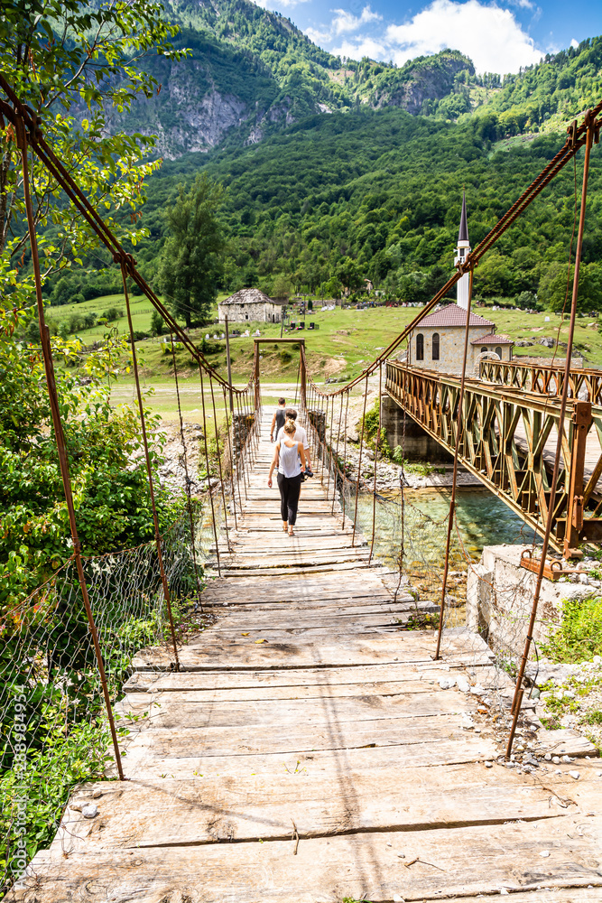 Obraz premium Old bridge in Dragobi over river Lumi i Valbones National Park Valbona in Albania, Europe