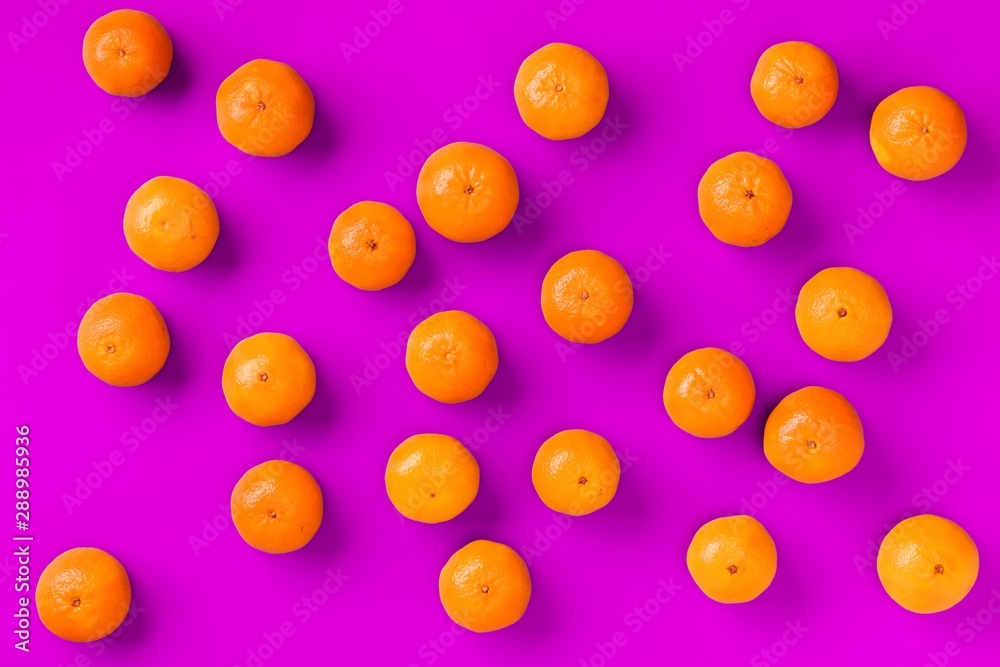 Fruit pattern of fresh orange tangerine or mandarin on lilac background. Flat lay, top view. Pop art design, creative summer concept. Citrus in minimal style. Fruit pattern of fresh orange tangerine or mandarin on lilac background. Flat lay, top view. Pop art design, creative summer concept. Citrus in minimal style.