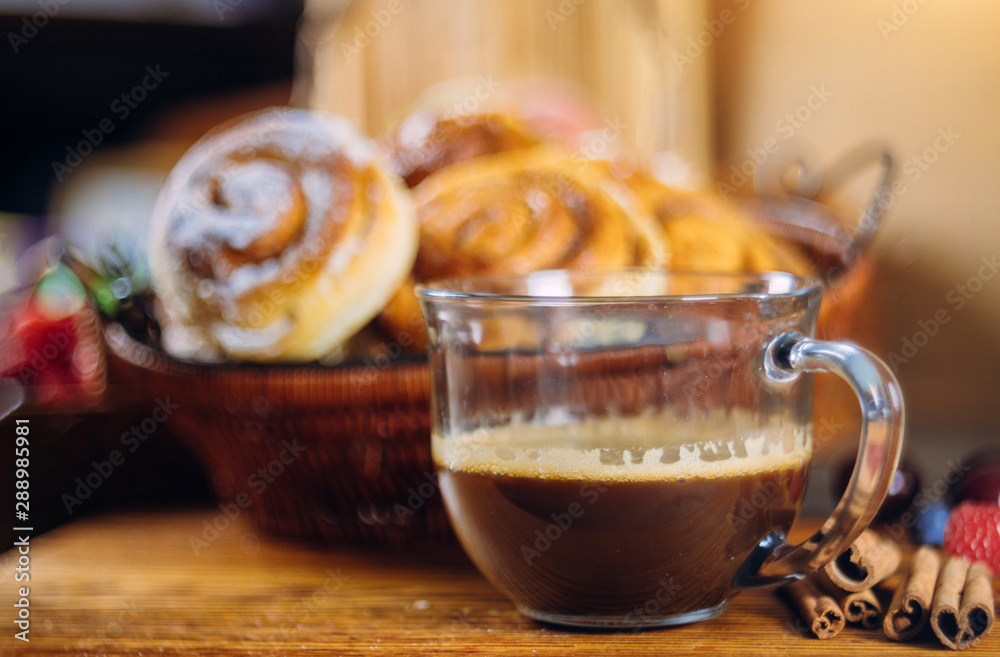 Cinnamon rolls with coffee on wooden table Cinnamon rolls with coffee on wooden table