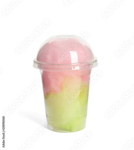 Plastic cup with tasty cotton candy on white background