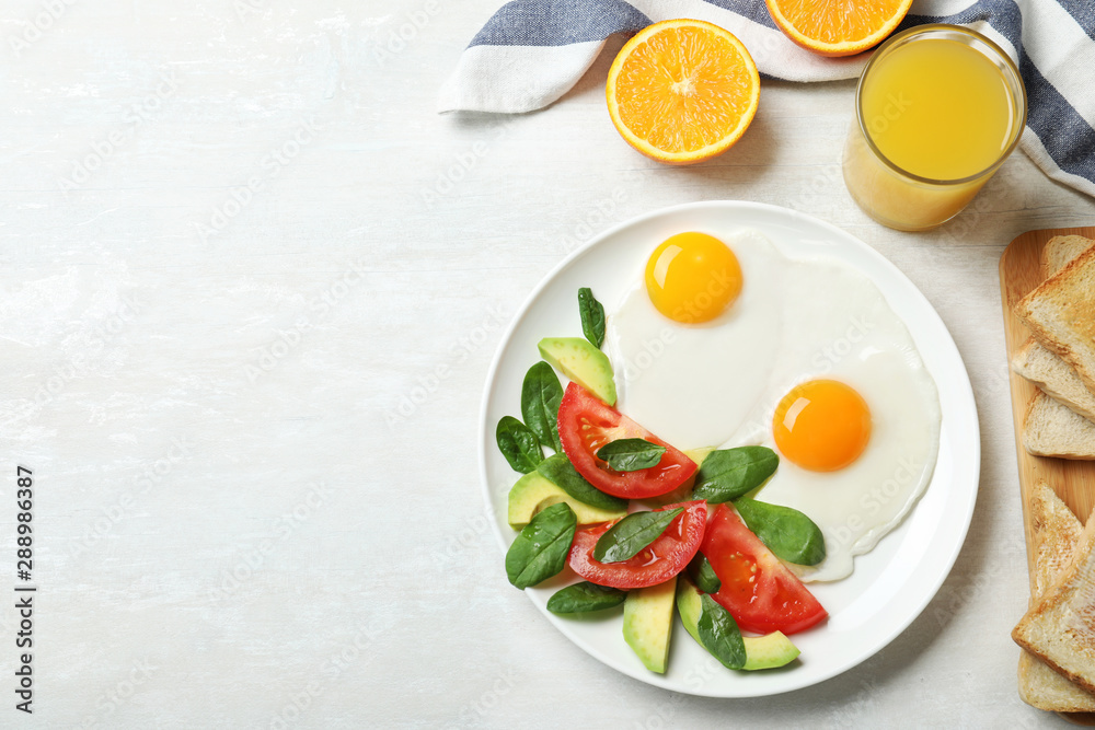 Delicious breakfast with fried eggs served on table, flat lay. Space for text
