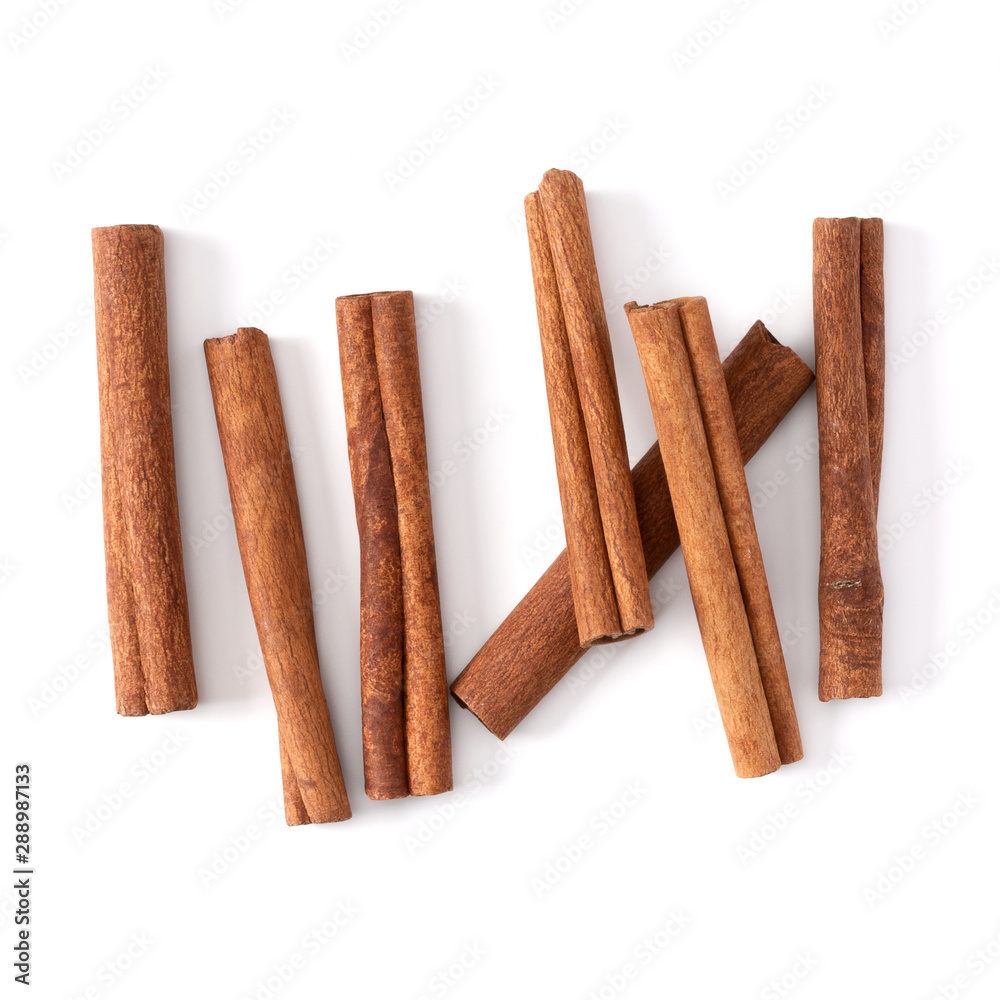 Cinnamon sticks isolated on white background closeup. Canella spice. Aromatic condiment background. Flat lay, top view. Cinnamon sticks isolated on white background closeup. Canella spice. Aromatic condiment background. Flat lay, top view.