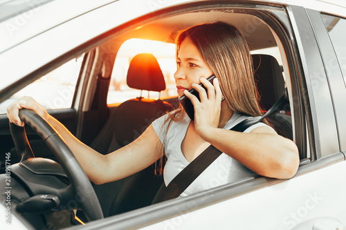 Distracted woman driving while talking on the cellphone © kleberpicui