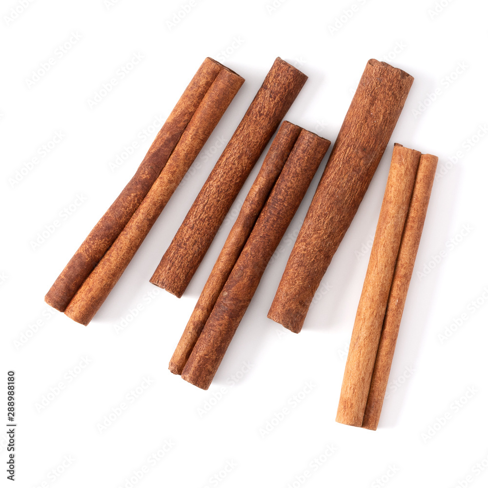 Cinnamon sticks isolated on white background closeup. Canella spice. Aromatic condiment background. Flat lay, top view. Cinnamon sticks isolated on white background closeup. Canella spice. Aromatic condiment background. Flat lay, top view.