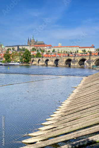 A view across the Charles Bridge and the Vltava River to Prague Castle and St. Vitas Cathedral in Prague, Czech Republic. photo