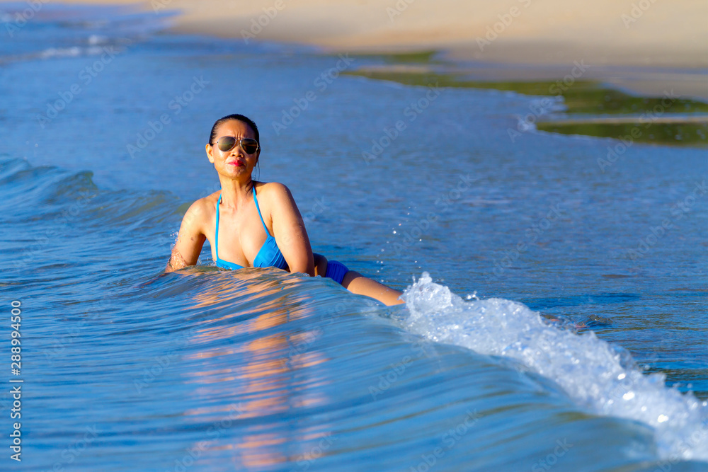Woman shape huge and bikini blue happy at the beach