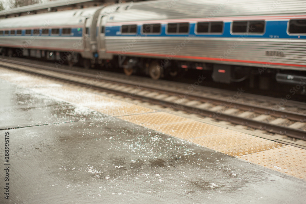 Fototapeta premium Icy train station platform has been salted