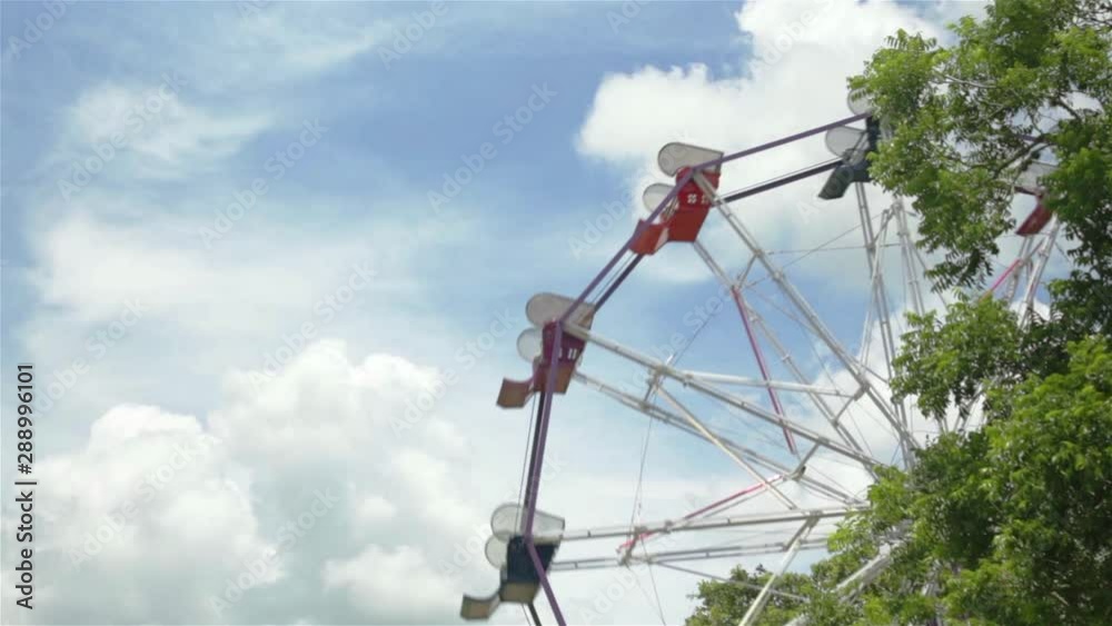 Sideview of Ferris Wheel with bright blue sky in the background. Sideview of Ferris Wheel with bright blue sky in the background.