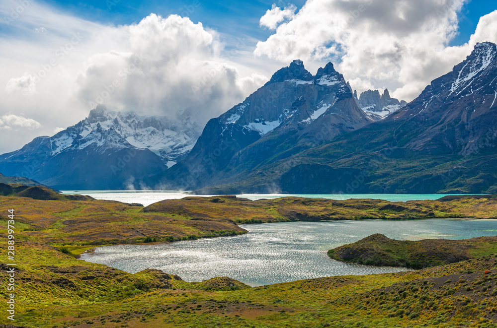 The colorful Nordenskjold and Pehoe Lake during summer in windy Patagonia with a dramatic sky, Torres del Paine national park, Puerto Natales, Chile.