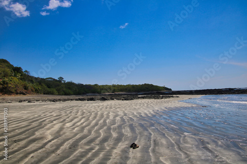 Fototapeta Naklejka Na Ścianę i Meble -  Endless beach with sandals in the sand