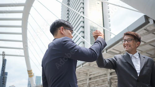 The businessman is making a handshake. Successful Negotiation. Business etiquette for greeting and congratulation each other.