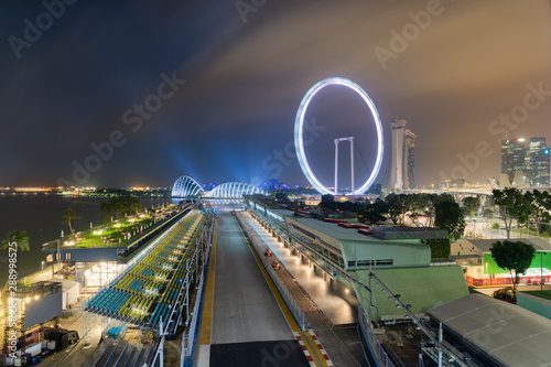 Singapore Formula One Grand Prix circuit at night, in front of the Marina Bay area and the Singapore Flyer Wheel photo