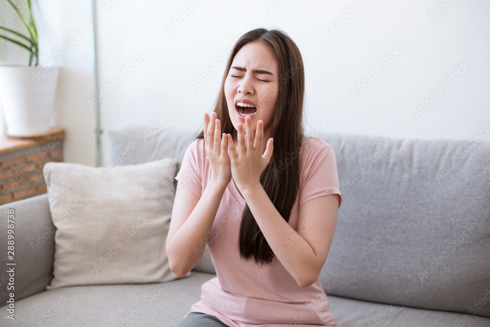 Young woman suffering from allergy. Young woman was sick and sneezing violently. Young woman suffering from allergy. Young woman was sick and sneezing violently.