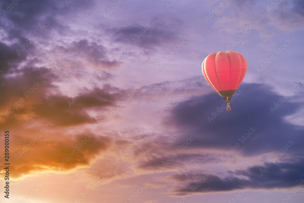 Fototapeta premium Colorful hot air balloon with dramatic sky at sunset