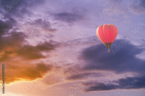Colorful hot air balloon with dramatic sky at sunset
