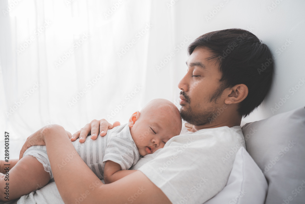 portrait of asian dad with his infant boy sleeping on his chest portrait of asian dad with his infant boy sleeping on his chest