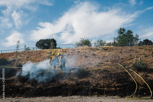 Firefighters extinguishing desert wildfire 