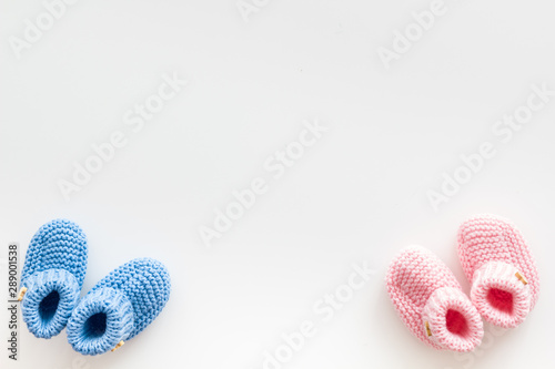 Booties for newborn boy and girl on white background top view mockup