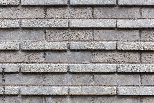 Closed up grey brick wall texture. Architectural material construction.