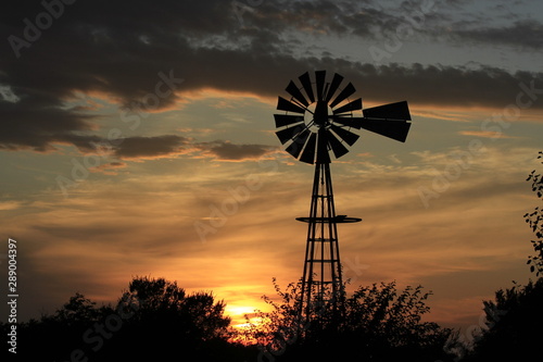 Kansas silhouette of windmill at sunset with cloud's.