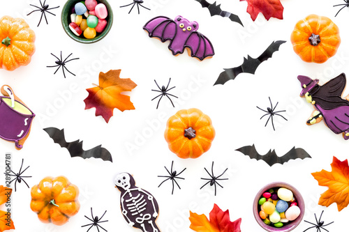 Nice halloween background with sweets. Cookies and pumpkins on white top view pattern © 9dreamstudio