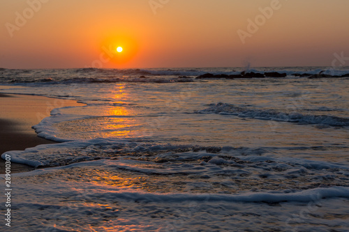 sunrise over the ocean with waves and golden light