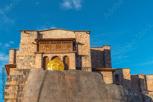 The inca sun temple or Qorikancha in Cusco city during Inti Raymi, hence the solar disk. Famous for its inca wall stonework and Santo Domingo convent built on top, Cusco, Peru. photo