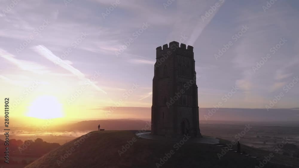 Zooming out aerial shot of the sunrise over Glastonbury Tor, Somerset. Zooming out aerial shot of the sunrise over Glastonbury Tor, Somerset.