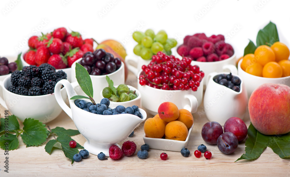 different summer berries red currant, gooseberry, raspberry in glass trays. sorted by type. superfoods from the garden different summer berries red currant, gooseberry, raspberry in glass trays. sorted by type. superfoods from the garden