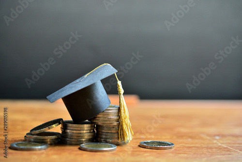 hat education model on money coins saving for concept investment education and scholarships photo