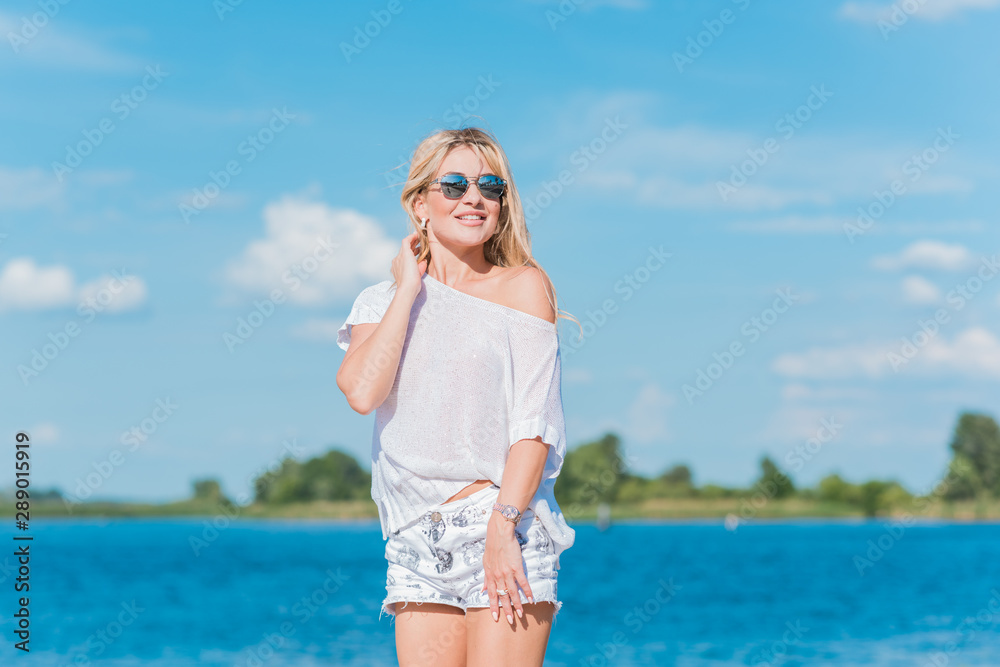 Adventure concept, blonde hair woman at the beach, vacation and holidays time Adventure concept, blonde hair woman at the beach, vacation and holidays time