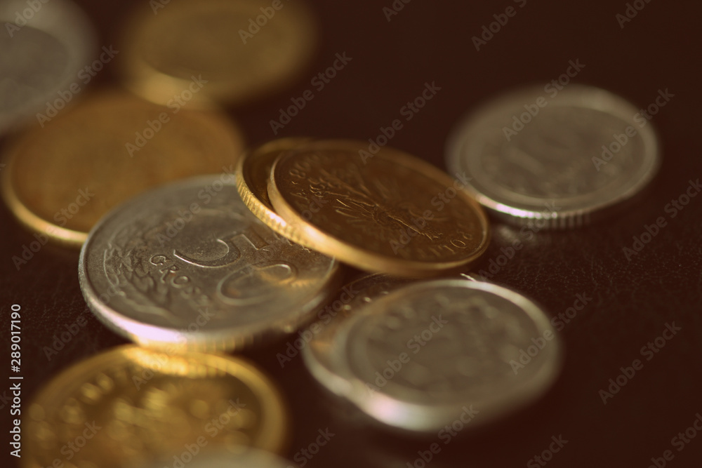 Polish coins scattered on a dark background close up. Retro style Polish coins scattered on a dark background close up. Retro style