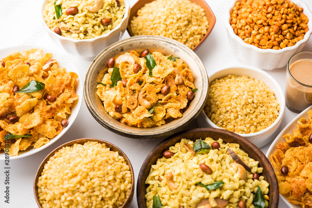 Group of Cornflake and Thick Poha Chivda or Chiwda and Chatpata Masala chana and fried crispy Moong Dal, served in a bowl. selective focus Group of Cornflake and Thick Poha Chivda or Chiwda and Chatpata Masala chana and fried crispy Moong Dal, served in a bowl. selective focus