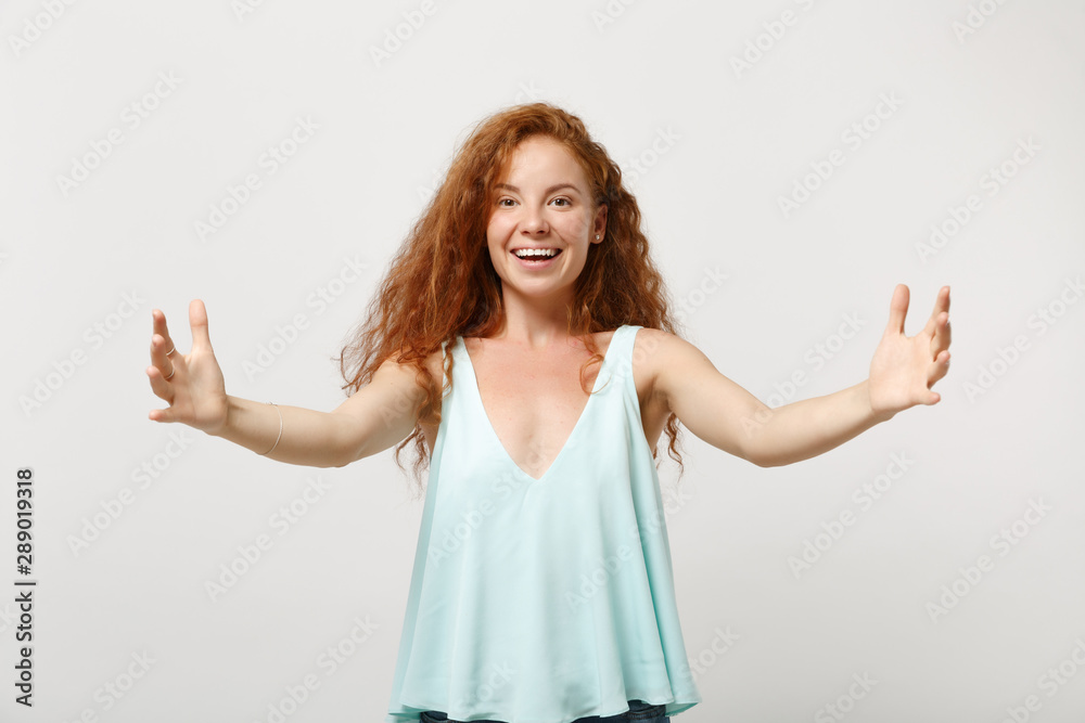 Young smiling redhead woman girl in casual light clothes posing isolated on white wall background. People lifestyle concept. Mock up copy space. Gesturing demonstrating size with horizontal workspace. Young smiling redhead woman girl in casual light clothes posing isolated on white wall background. People lifestyle concept. Mock up copy space. Gesturing demonstrating size with horizontal workspace.