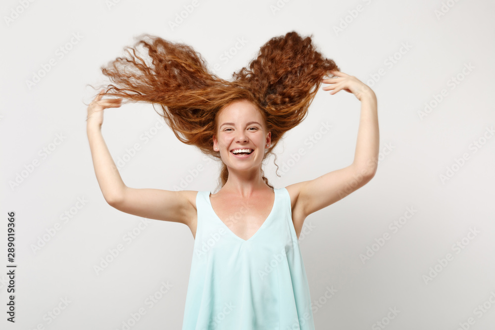 Young happy funny redhead woman girl in casual light clothes posing isolated on white background in studio. People lifestyle concept. Mock up copy space. Having fun, fooling around with flying hair. Young happy funny redhead woman girl in casual light clothes posing isolated on white background in studio. People lifestyle concept. Mock up copy space. Having fun, fooling around with flying hair.