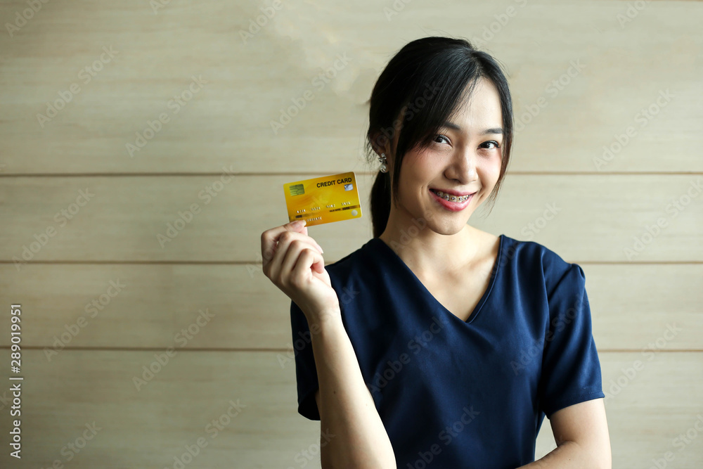 Portrait Asia smiling woman with credit card in hand,happy to have money concept. Portrait Asia smiling woman with credit card in hand,happy to have money concept.