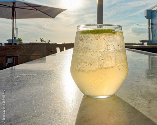 Tableau sur toile Rooftop view of sunset with a drink on the bar