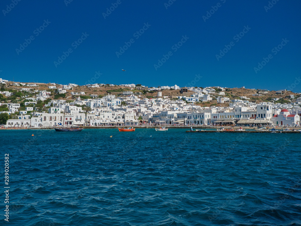Picturesque seascape with boats and white buildings