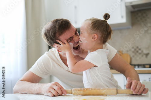 gentle loving dad hugs his daughter kitchen