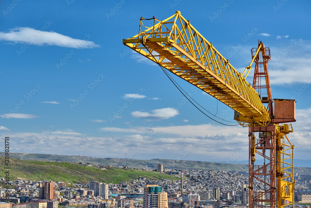 Εκτύπωση καμβά Yellow construction jib crane tower against blue sky